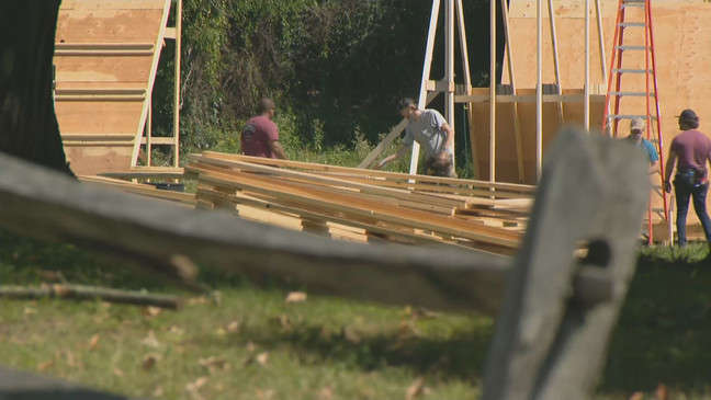 Set building for 'Hocus Pocus 2' in Rhode Island, showing crew constructing wooden frames for a movi.