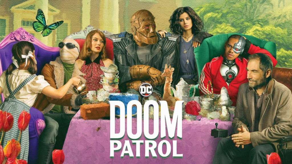Doom Patrol characters gathered around a table with colorful props and decorations.
