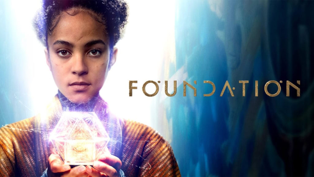 A young girl holding a glowing, futuristic cube with the word "FOUNDATION" in the background.