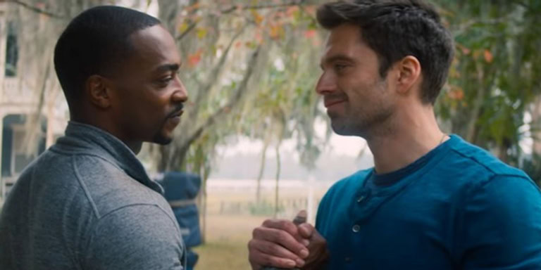 A man and woman having a friendly conversation outdoors in a park.