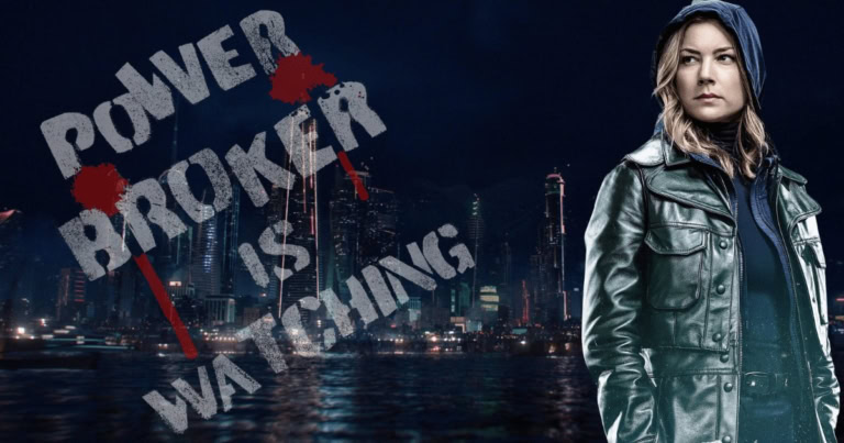 Empowered woman standing by city skyline at night with graffiti message "Power Broken is Watching".