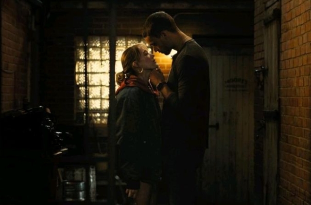 Tyriq Withers and Maika Monroe in Reminders of Him movie 2026 Intimate moment between a man and woman in a dimly lit alleyway.