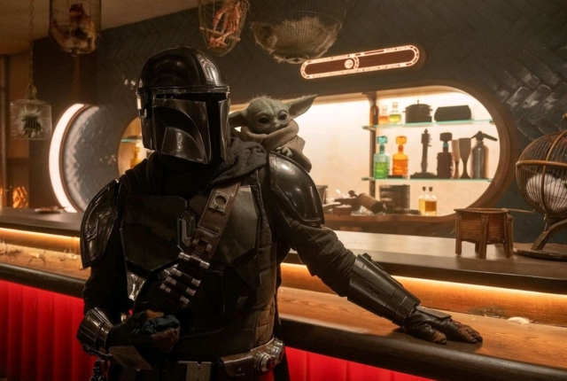 Bounty Hunter with Grogu at a sci-fi bar from The Mandalorian series.