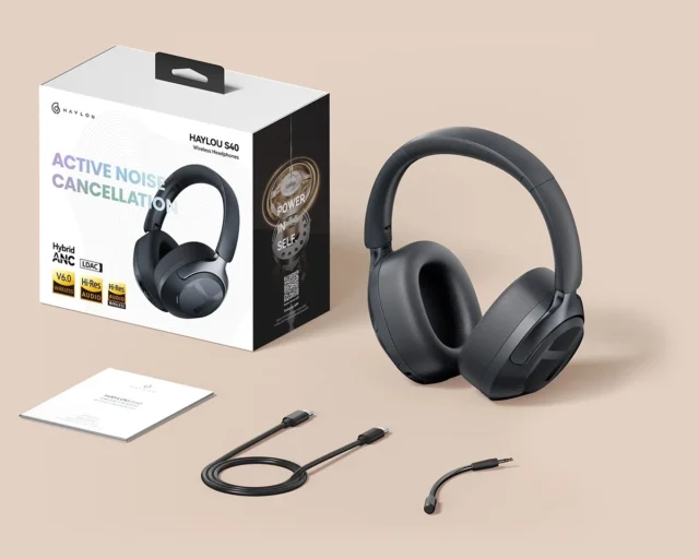 Haylou S40 wireless headphones with accessories and packaging on a beige background.