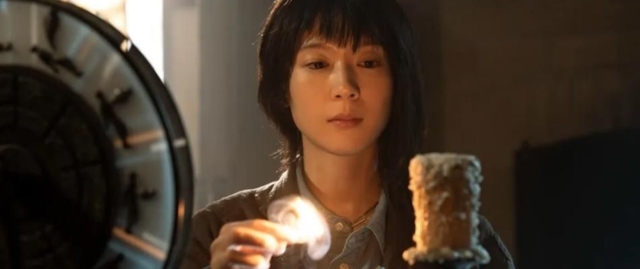 Young woman examining a scientific experiment with a candle and glassware. Still from the film Never after Dark courtesy of Fantasia Fest 2026