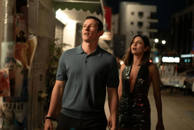 Couple walking at night in an urban setting with city lights. A scene from the movie One Night Only (2026)
