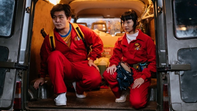 A scene from the movie Kung Fu Deadly . Two emergency responders sitting in the back of an ambulance, ready for action.