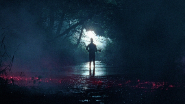 A scene from the film Pathetic Fallacy (Courtesy of Fantastic Fest 2026) Mysterious figure standing in a foggy, moonlit forest stream at night.