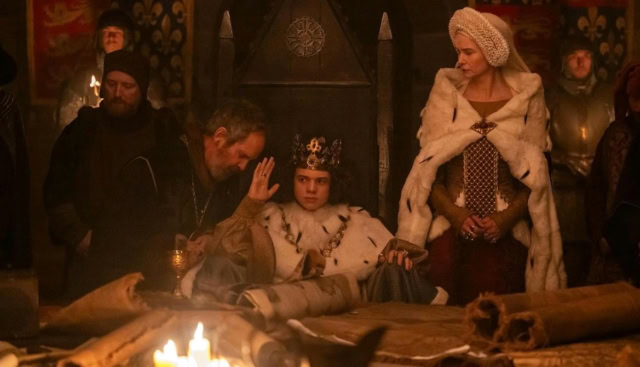 Scene from a medieval or fantasy-themed film or TV show with characters in period costumes.